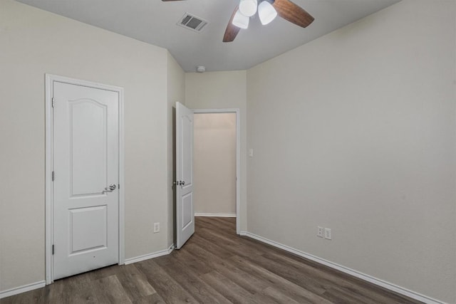 2141 Rachel Ln, Round Rock, TX 78664 - unfurnished bedroom with wood finished floors, baseboards, and a ceiling fan