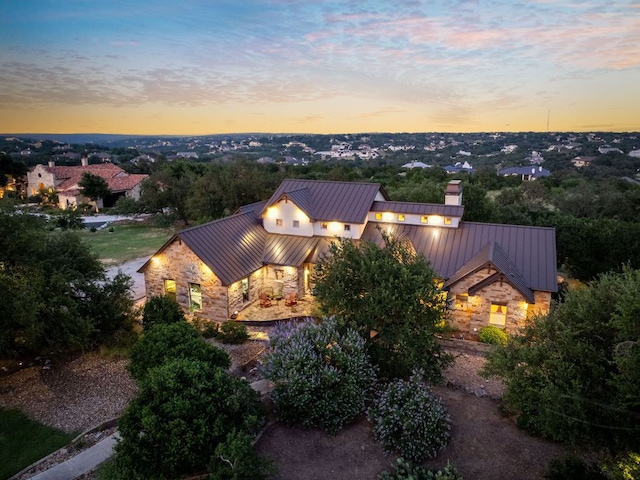 1606 Bordeaux Blanc, New Braunfels, TX 78132 - view of property exterior with stone siding, a standing seam roof, metal roof, and a chimney