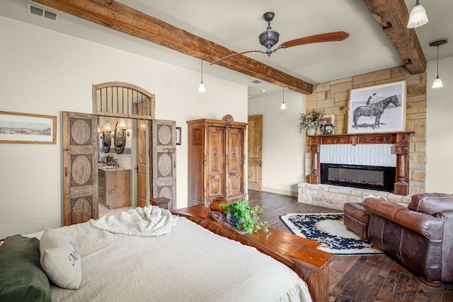 1606 Bordeaux Blanc, New Braunfels, TX 78132 - bedroom featuring beamed ceiling, wood finished floors, and a glass covered fireplace