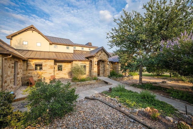 1606 Bordeaux Blanc, New Braunfels, TX 78132 - view of front of home with a standing seam roof, stone siding, and metal roof
