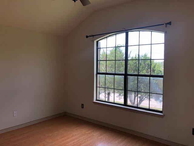 22340 Briarcliff Dr, Spicewood, TX 78669 - unfurnished room featuring a ceiling fan, light wood finished floors, vaulted ceiling, and baseboards