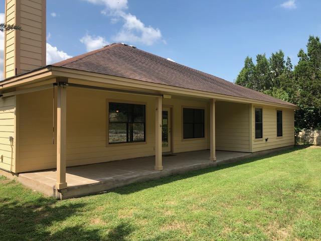22340 Briarcliff Dr, Spicewood, TX 78669 - rear view of property with a chimney, a lawn, and a patio area