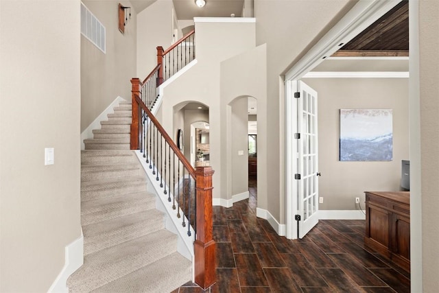 121 White Wash, Dripping Springs, TX 78620 - staircase featuring arched walkways, baseboards, and wood tiled floors
