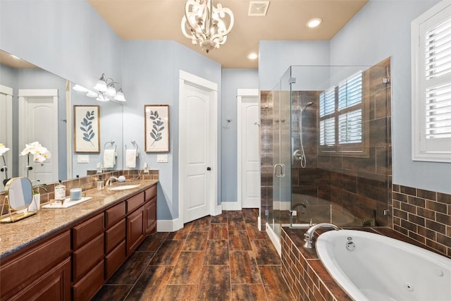 121 White Wash, Dripping Springs, TX 78620 - bathroom featuring a jetted tub, a chandelier, a stall shower, vanity, and baseboards