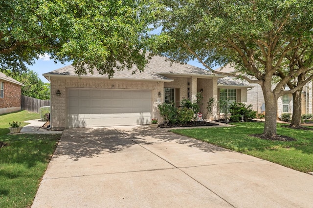 2600 Lost Mine Trl, Leander, TX 78641 - view of front facade with brick siding, driveway, a garage, and a shingled roof