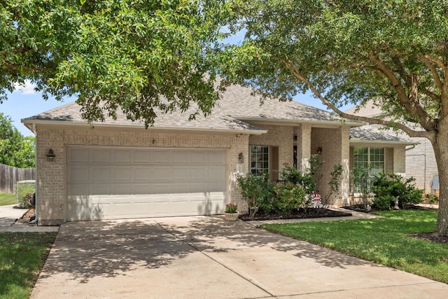 2600 Lost Mine Trl, Leander, TX 78641 - view of front facade featuring brick siding, a garage, driveway, and roof with shingles