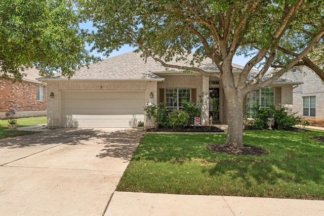 2600 Lost Mine Trl, Leander, TX 78641 - view of front of property with an attached garage, brick siding, a front lawn, and concrete driveway