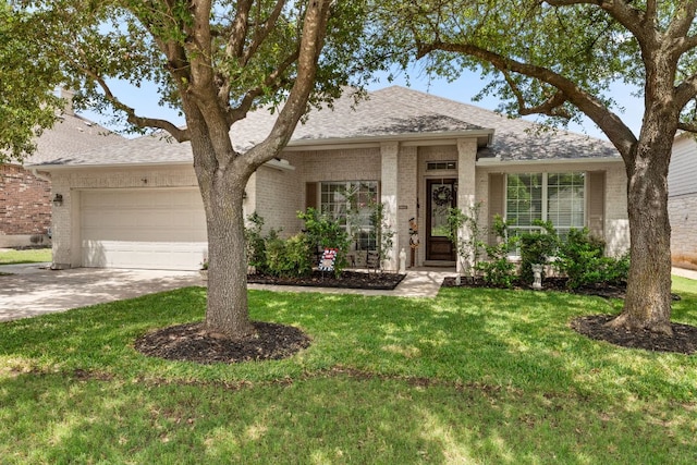2600 Lost Mine Trl, Leander, TX 78641 - view of front of property featuring brick siding, an attached garage, driveway, a front yard, and roof with shingles