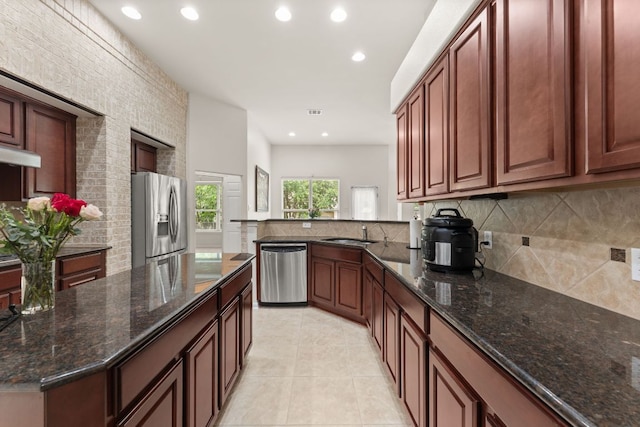 2600 Lost Mine Trl, Leander, TX 78641 - kitchen featuring stainless steel appliances, backsplash, recessed lighting, dark stone counters, and light tile patterned floors