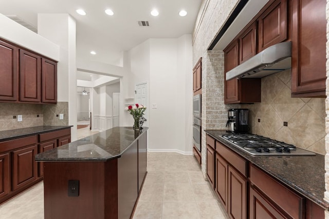 2600 Lost Mine Trl, Leander, TX 78641 - kitchen with stainless steel appliances, under cabinet range hood, dark stone counters, recessed lighting, and backsplash