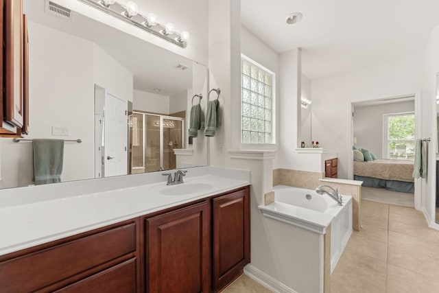 2600 Lost Mine Trl, Leander, TX 78641 - ensuite bathroom featuring a shower stall, vanity, a garden tub, and tile patterned floors