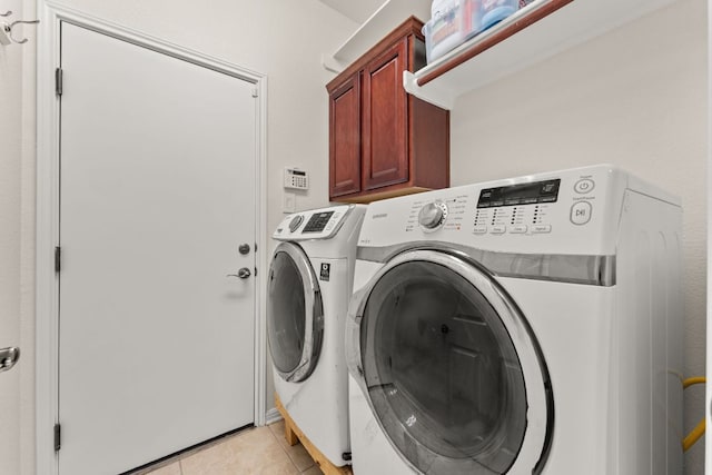 2600 Lost Mine Trl, Leander, TX 78641 - laundry room featuring washer and clothes dryer, cabinet space, and light tile patterned floors