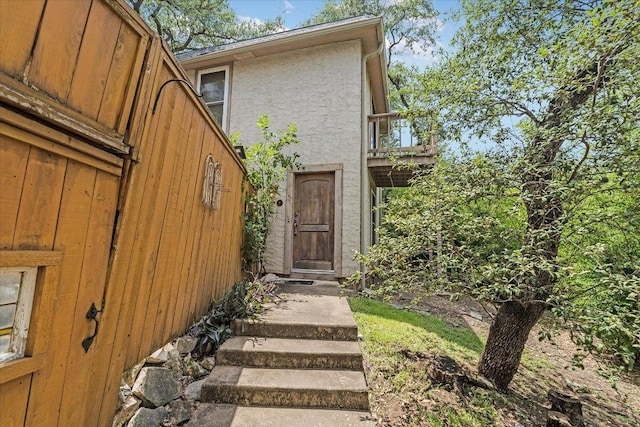 3304 Clawson Rd, Austin, TX 78704 - view of exterior entry featuring stucco siding and a balcony
