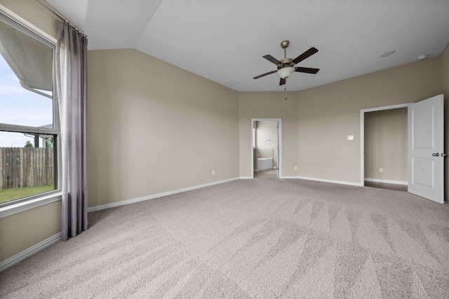 202 Westfield St, Hutto, TX 78634 - unfurnished bedroom with carpet flooring, baseboards, lofted ceiling, ensuite bath, and ceiling fan