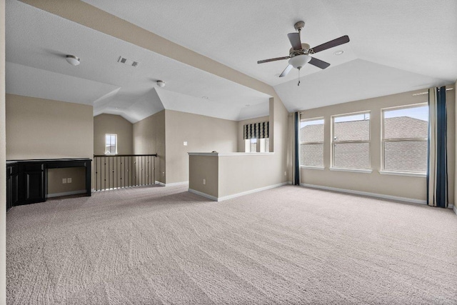 202 Westfield St, Hutto, TX 78634 - unfurnished living room with lofted ceiling, carpet floors, ceiling fan, and baseboards