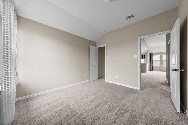 202 Westfield St, Hutto, TX 78634 - unfurnished bedroom with carpet, baseboards, and lofted ceiling