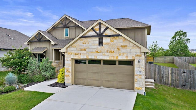 202 Westfield St, Hutto, TX 78634 - craftsman-style home with stone siding, board and batten siding, roof with shingles, and driveway