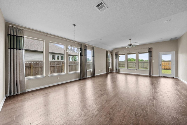 202 Westfield St, Hutto, TX 78634 - unfurnished living room with ceiling fan, wood finished floors, baseboards, and a textured ceiling