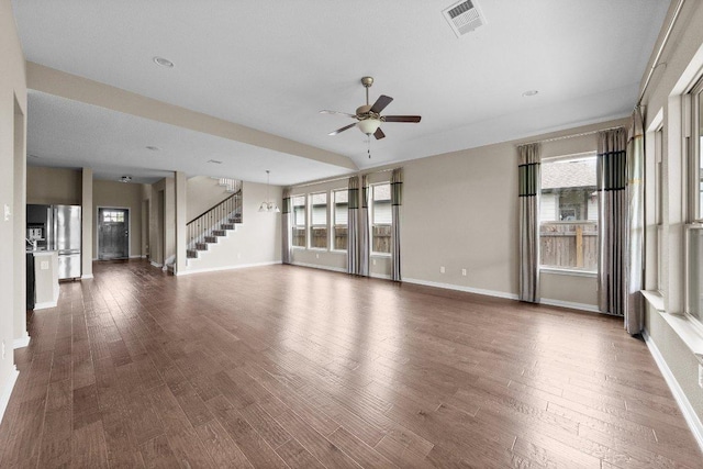 202 Westfield St, Hutto, TX 78634 - unfurnished living room featuring a ceiling fan, baseboards, stairway, and wood finished floors