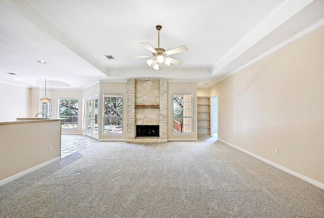 106 Los Altos Dr, Lakeway, TX 78734 - unfurnished living room with a tray ceiling, crown molding, light colored carpet, ceiling fan, and baseboards