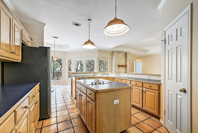 106 Los Altos Dr, Lakeway, TX 78734 - kitchen featuring black electric cooktop, freestanding refrigerator, crown molding, a kitchen island, and hanging light fixtures