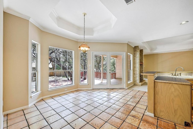 106 Los Altos Dr, Lakeway, TX 78734 - unfurnished dining area with ornamental molding, a tray ceiling, a sink, french doors, and a chandelier