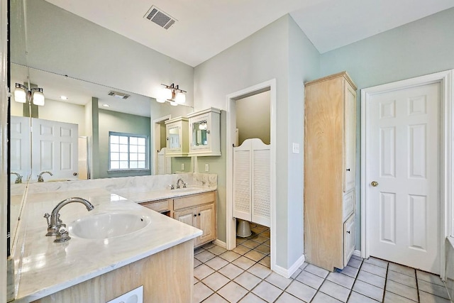 106 Los Altos Dr, Lakeway, TX 78734 - full bath featuring double vanity, tile patterned flooring, baseboards, and a closet