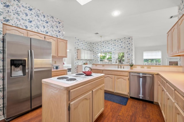 10601 Beckwood Dr, Austin, TX 78726 - kitchen with appliances with stainless steel finishes, wallpapered walls, light brown cabinetry, and light countertops