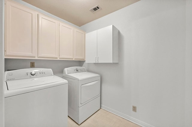 10601 Beckwood Dr, Austin, TX 78726 - laundry room featuring independent washer and dryer, cabinet space, and baseboards