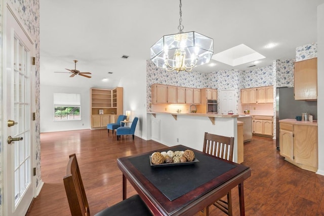 10601 Beckwood Dr, Austin, TX 78726 - dining area with dark wood finished floors, a chandelier, and ceiling fan