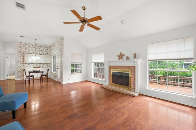 10601 Beckwood Dr, Austin, TX 78726 - unfurnished living room featuring wallpapered walls, baseboards, ceiling fan, lofted ceiling, and wood finished floors