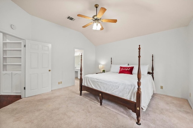 10601 Beckwood Dr, Austin, TX 78726 - carpeted bedroom featuring vaulted ceiling, ceiling fan, ensuite bathroom, and baseboards