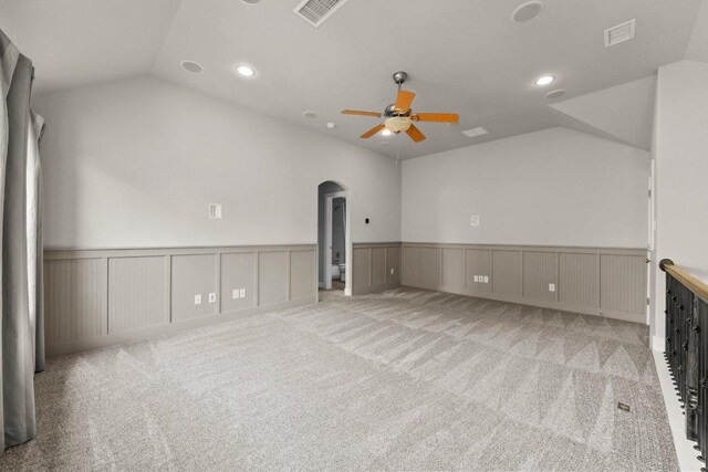 20525 Martin Ln, Pflugerville, TX 78660 - carpeted empty room with ceiling fan, vaulted ceiling, arched walkways, a wainscoted wall, and recessed lighting