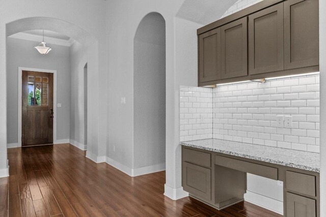 20525 Martin Ln, Pflugerville, TX 78660 - entryway featuring ornamental molding, arched walkways, dark wood-type flooring, and baseboards