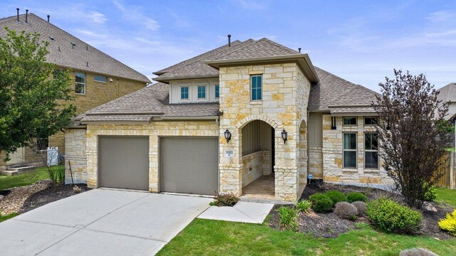 20525 Martin Ln, Pflugerville, TX 78660 - french provincial home with roof with shingles, stone siding, driveway, and a garage