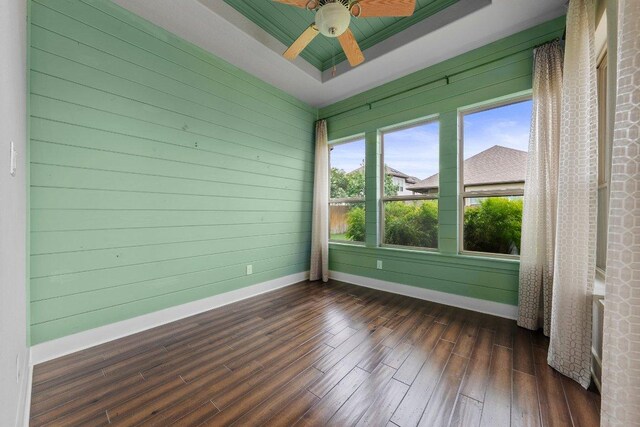 20525 Martin Ln, Pflugerville, TX 78660 - spare room with baseboards, dark wood finished floors, a ceiling fan, and a raised ceiling