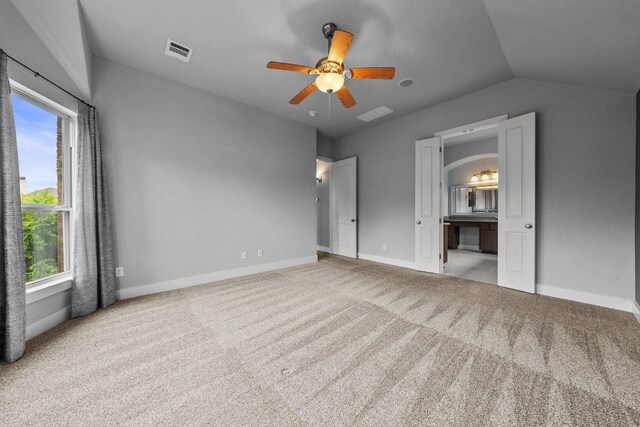 20525 Martin Ln, Pflugerville, TX 78660 - unfurnished bedroom featuring carpet, vaulted ceiling, baseboards, connected bathroom, and a ceiling fan