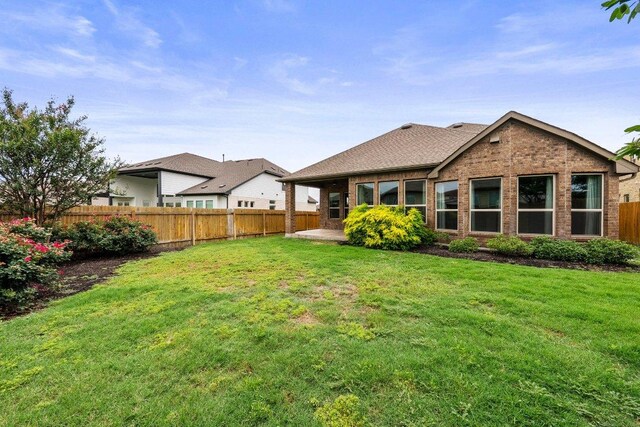 20525 Martin Ln, Pflugerville, TX 78660 - rear view of house with brick siding and a patio area