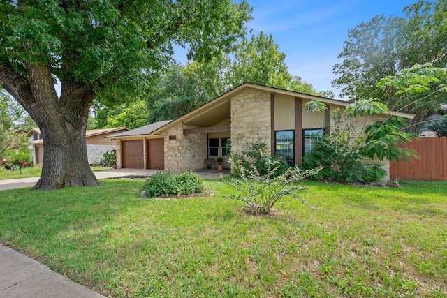 1515 Mearns Meadow Blvd, Austin, TX 78758 - mid-century home featuring stone siding, concrete driveway, and an attached garage