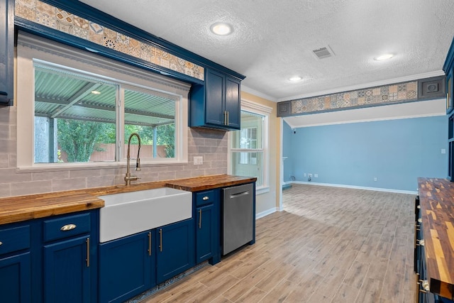 1515 Mearns Meadow Blvd, Austin, TX 78758 - kitchen featuring wooden counters, stainless steel dishwasher, a sink, tasteful backsplash, and crown molding