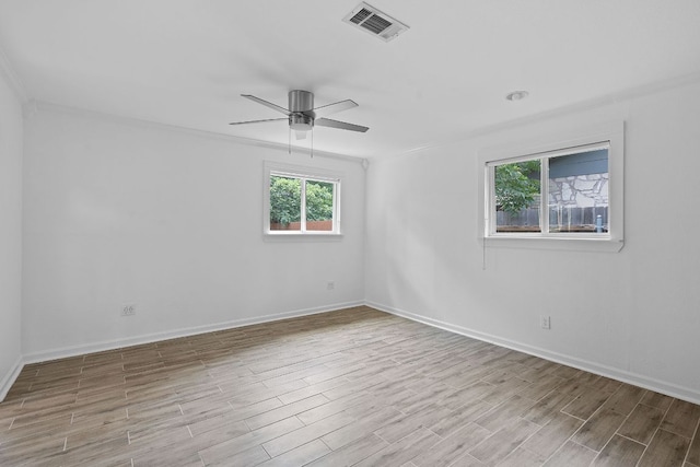 1515 Mearns Meadow Blvd, Austin, TX 78758 - unfurnished room with wood finished floors, baseboards, ceiling fan, and crown molding