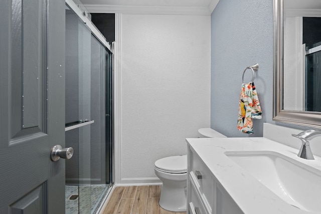 1515 Mearns Meadow Blvd, Austin, TX 78758 - bathroom featuring toilet, vanity, a stall shower, wood finished floors, and baseboards