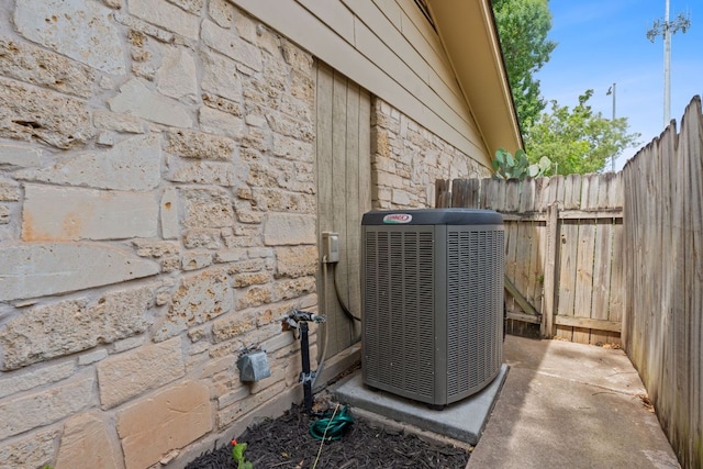 1515 Mearns Meadow Blvd, Austin, TX 78758 - exterior view of central AC unit and stone siding