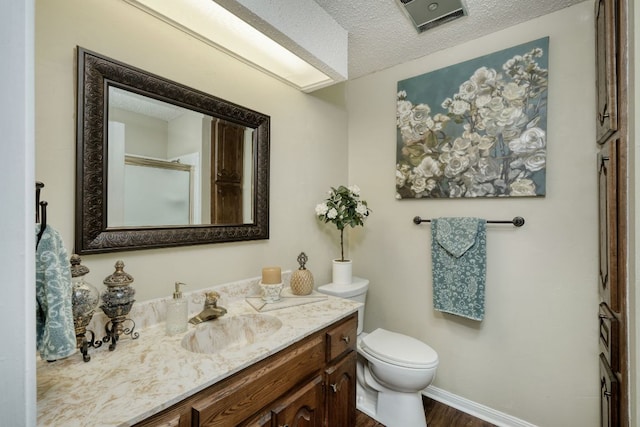 1604 W Creek Loop, Round Rock, TX 78681 - full bathroom featuring vanity, a textured ceiling, wood finished floors, and a shower with door