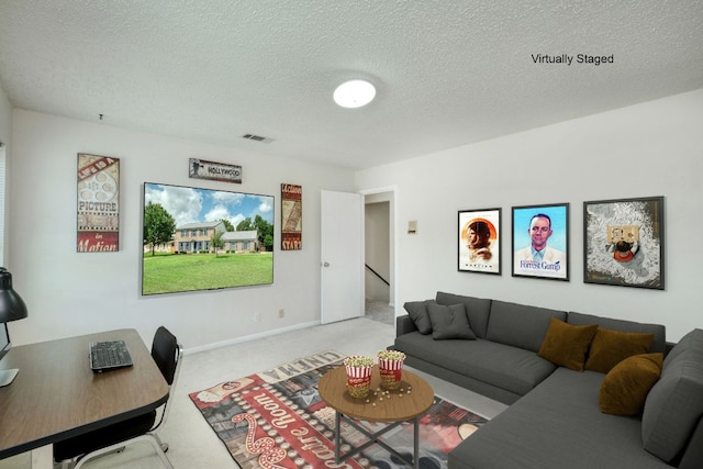 1604 W Creek Loop, Round Rock, TX 78681 - carpeted living room with a textured ceiling and a desk