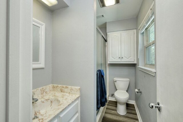 1604 W Creek Loop, Round Rock, TX 78681 - bathroom featuring wood finished floors, vanity, and a shower with shower door