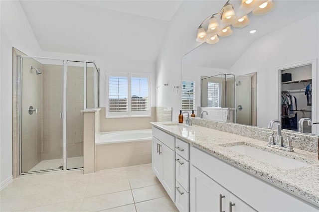 200 Ottaviano Way, Hutto, TX 78634 - full bath with vaulted ceiling, a shower stall, double vanity, a bath, and a walk in closet
