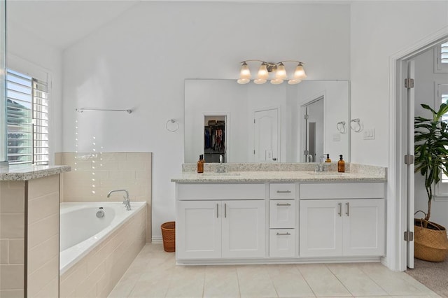200 Ottaviano Way, Hutto, TX 78634 - full bath featuring double vanity, tile patterned flooring, a bath, and a walk in closet