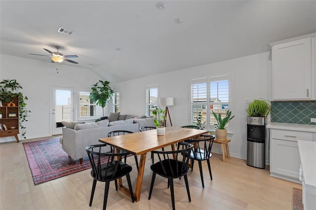 200 Ottaviano Way, Hutto, TX 78634 - dining area with lofted ceiling, a ceiling fan, light wood-style flooring, and baseboards