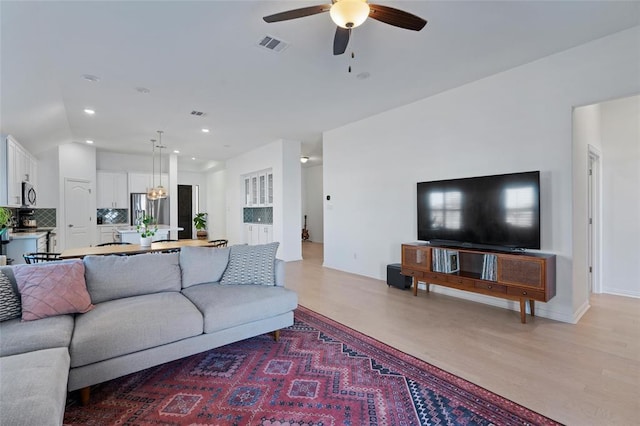 200 Ottaviano Way, Hutto, TX 78634 - living area featuring ceiling fan, recessed lighting, and light wood-style flooring